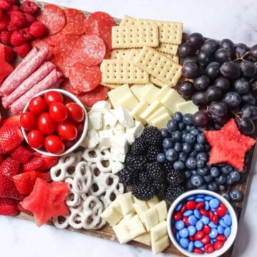 patriotic charcuterie board with red, white and blue foods