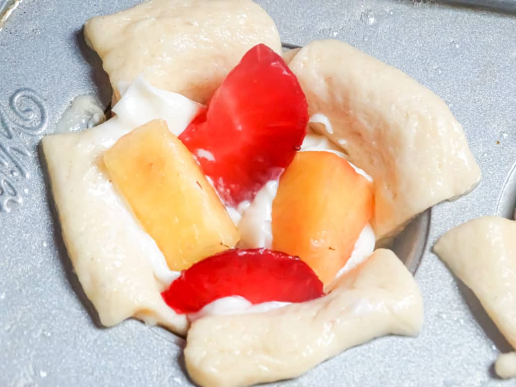 mini croissant cups filled with danish cream filling and strawberry and peach