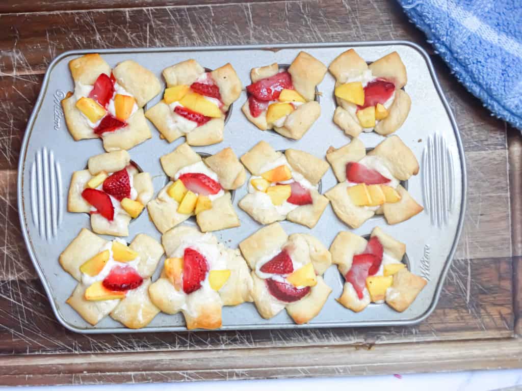 mini croissant cups filled with danish cream filling and strawberry and peach