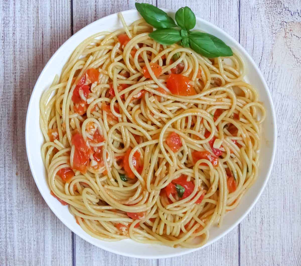 fresh tomato sauce with pasta and basil in a plate