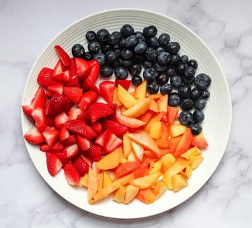 chopped fruit on a white plate