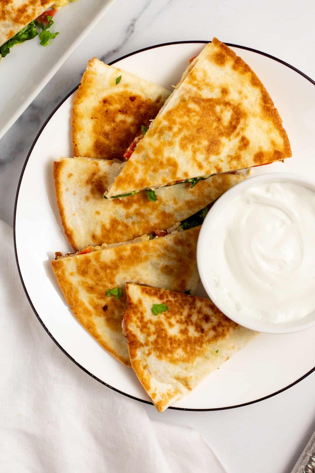 sliced mediterranean quesadillas on a plate with dipping cream