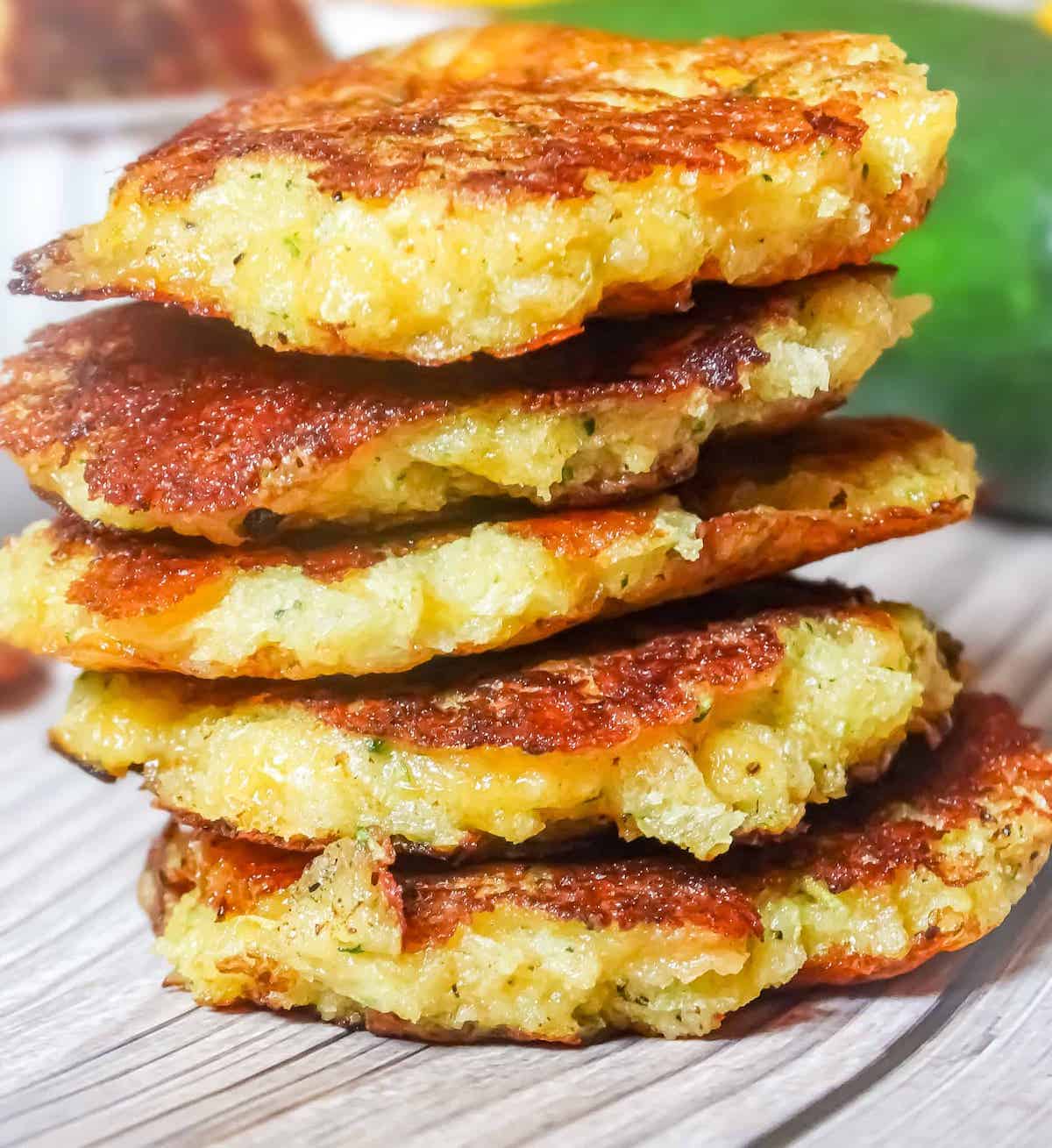 zucchini fritters in a stack on a plate