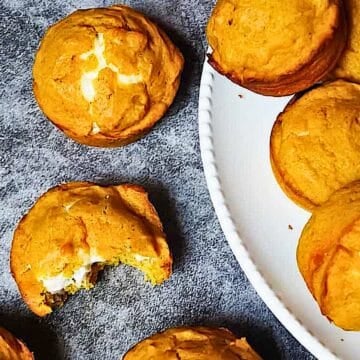 pumpkin cream cheese muffins on a cooling rack