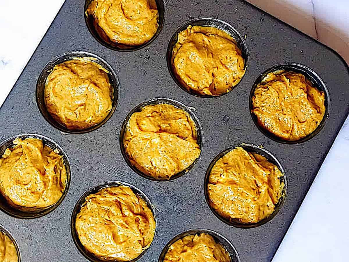pumpkin muffins uncooked in a muffin tin