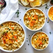 instant pot broccoli cheddar mac and cheese in white bowls