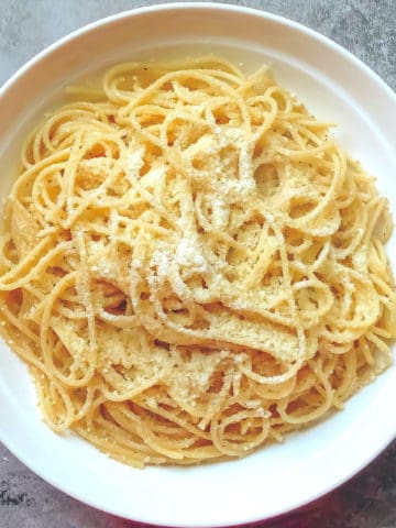 pasta with butter and parmesan on a white serving bowl