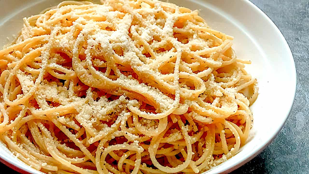 pasta with butter and parmesan in a white serving plate 