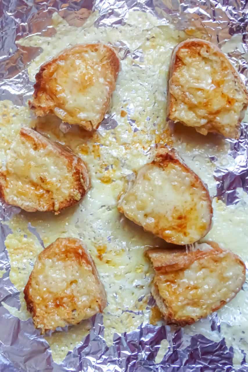 Bread slices topped with melted Gruyere cheese 