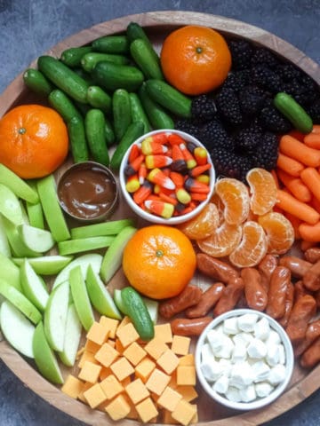 a healthy halloween snack board with fruits and veggies