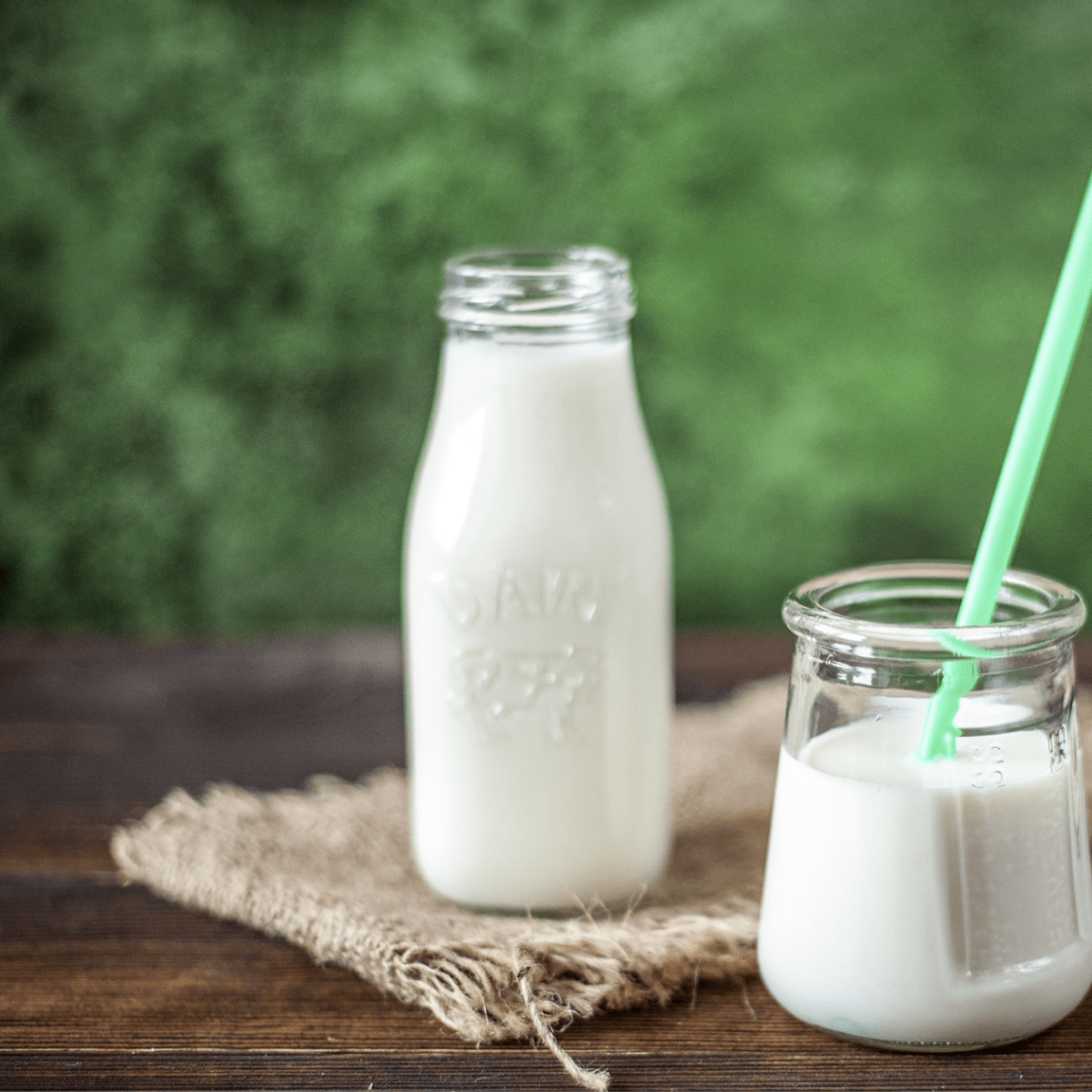 milk in 2 jugs outside on a table