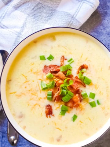 slow cooker potato soup with bacon in a white bowl