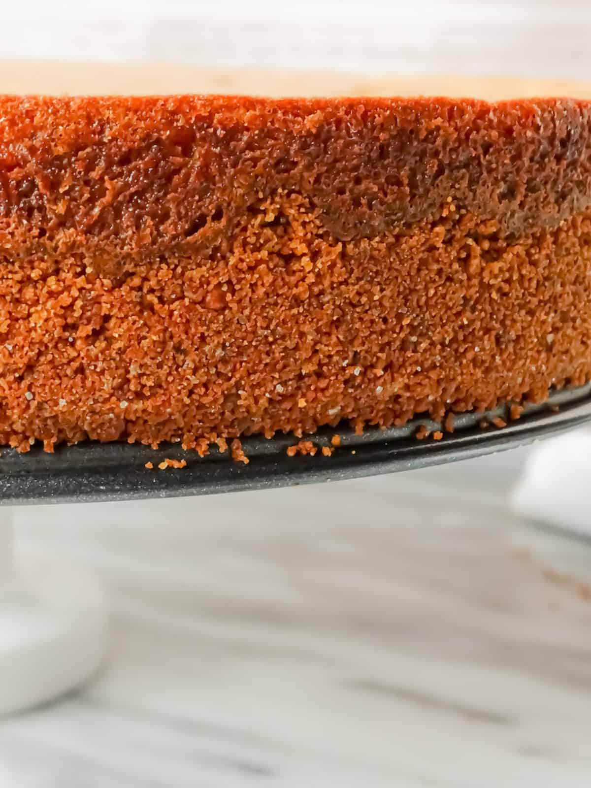 closeup of orange sides of a pumpkin cheesecake