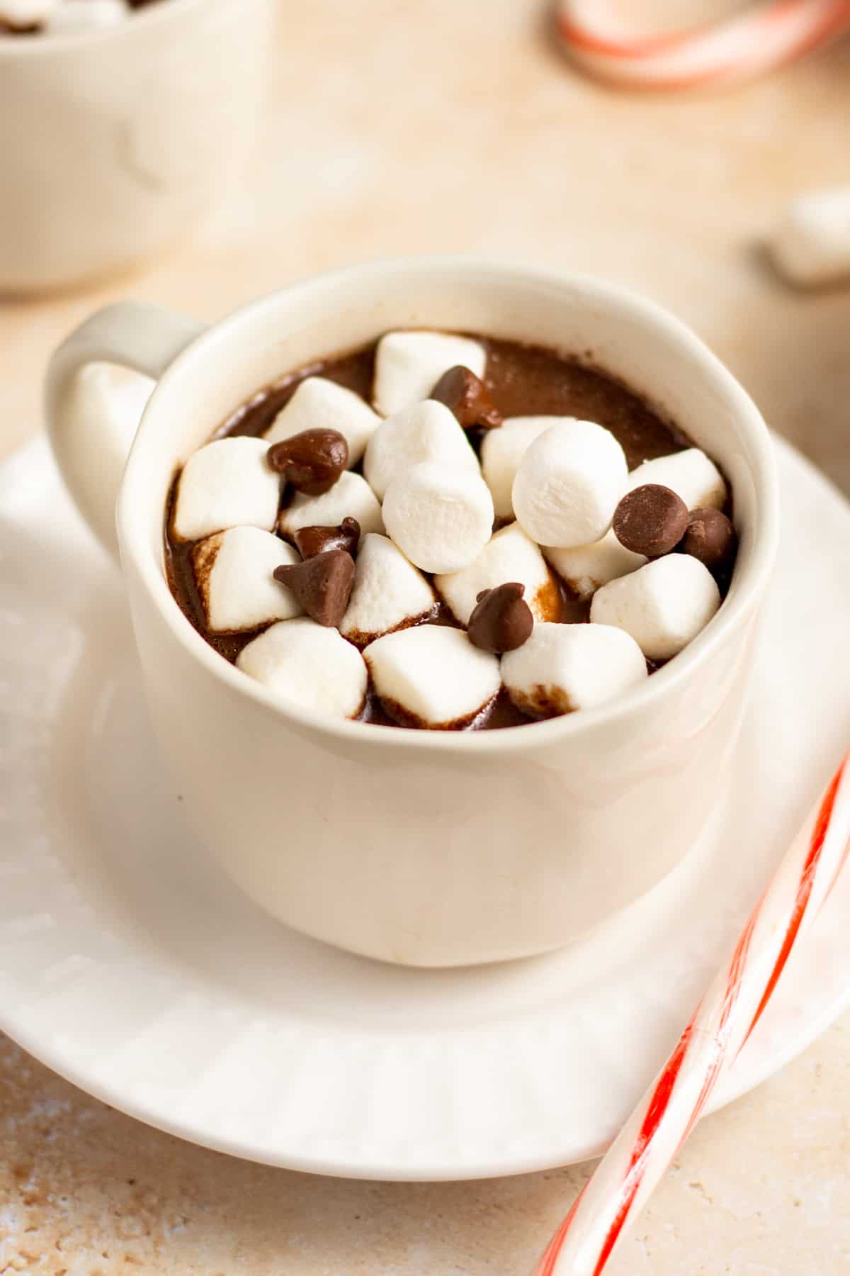 a mug ot pressure cooker hot cocoa topped with marshmallows and chocolate 
