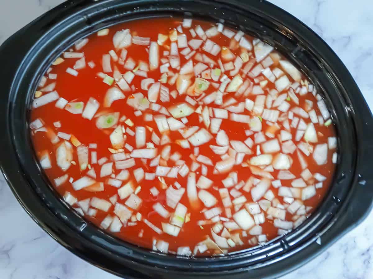 chicken broth, onions, garlic, tomatoes, and chicken in a crockpot