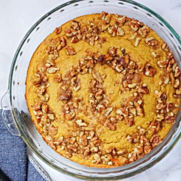 pumpkin cornbread in a pie plate with walnut topping