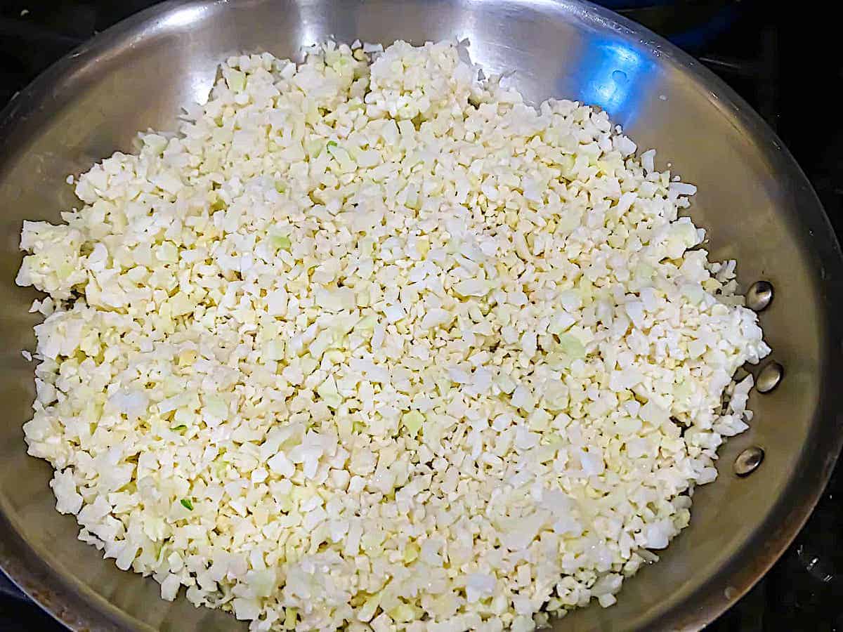 cauliflower rice cooking in a pan