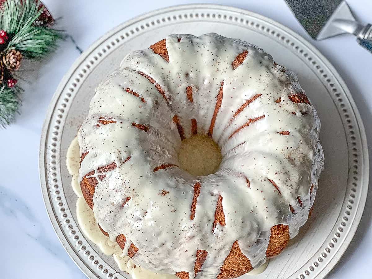 eggnog cake topped with glaze on a white plate