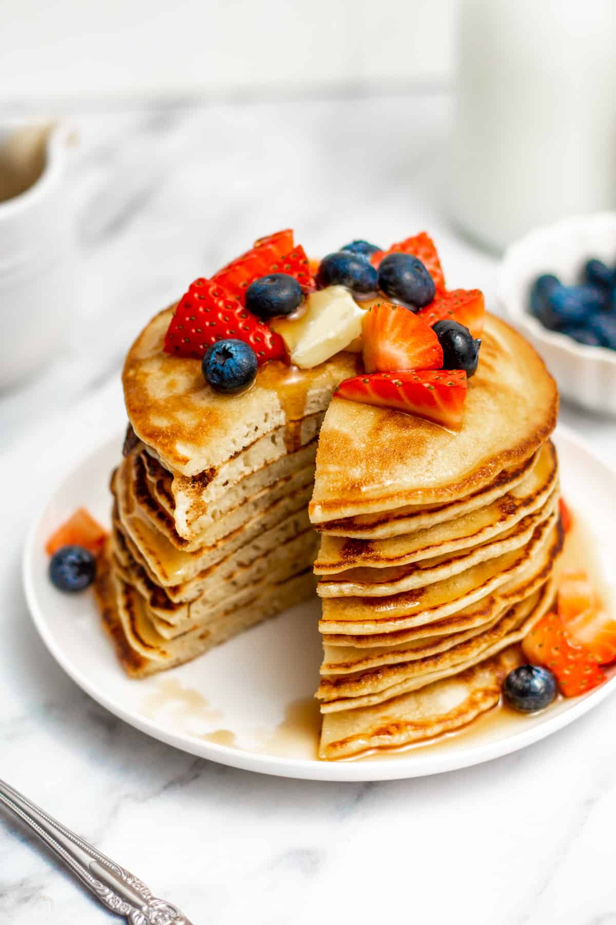 oat milk pancakes in a stack with a bite taken out