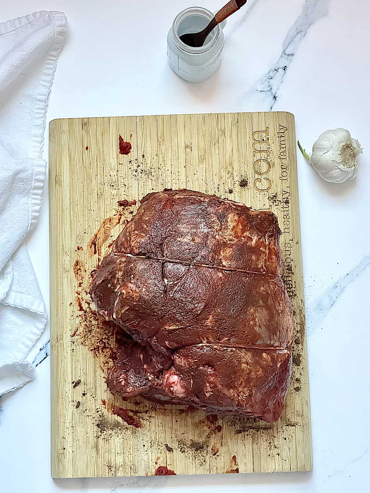 bone in leg of lamb rubbed with spices and tomato paste