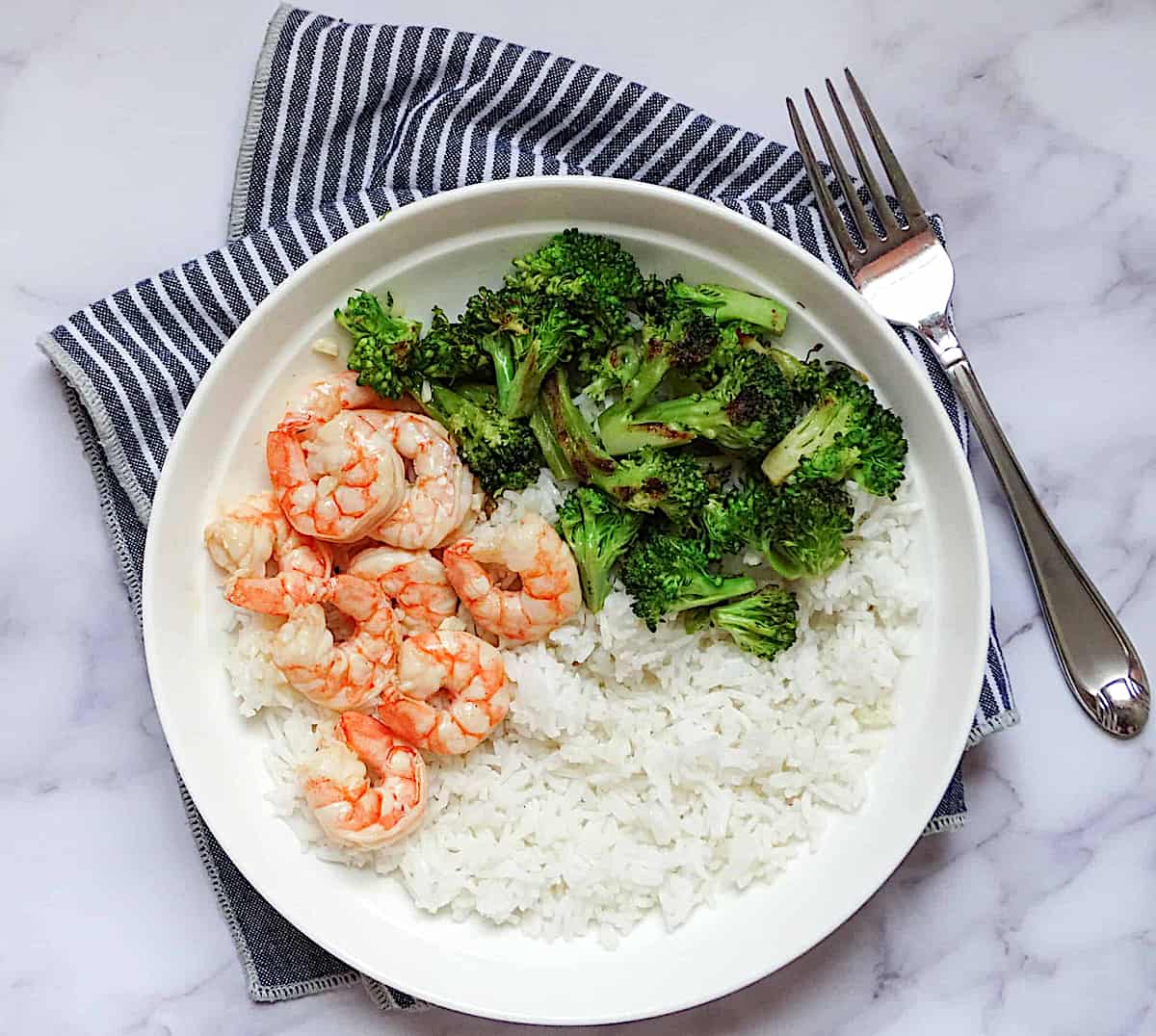 shrimp, broccoli and rice on a white plate