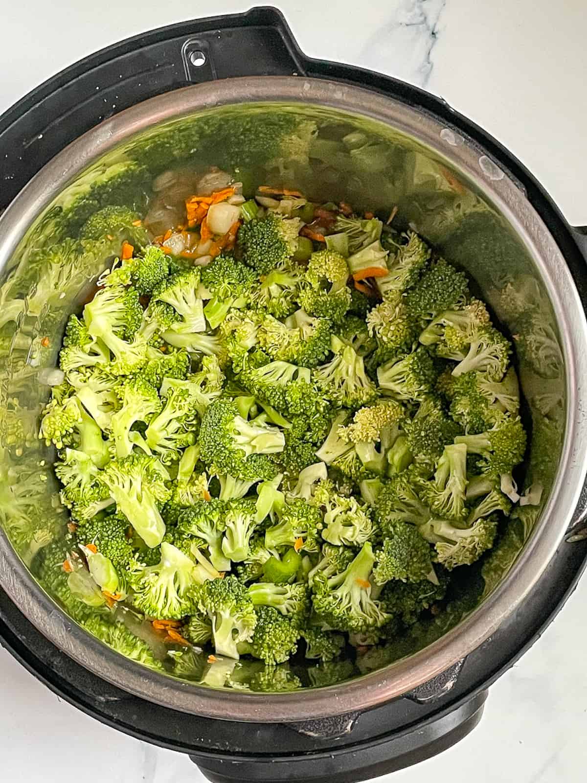 broccoli, carrots, onions, and garlic in the instant pot