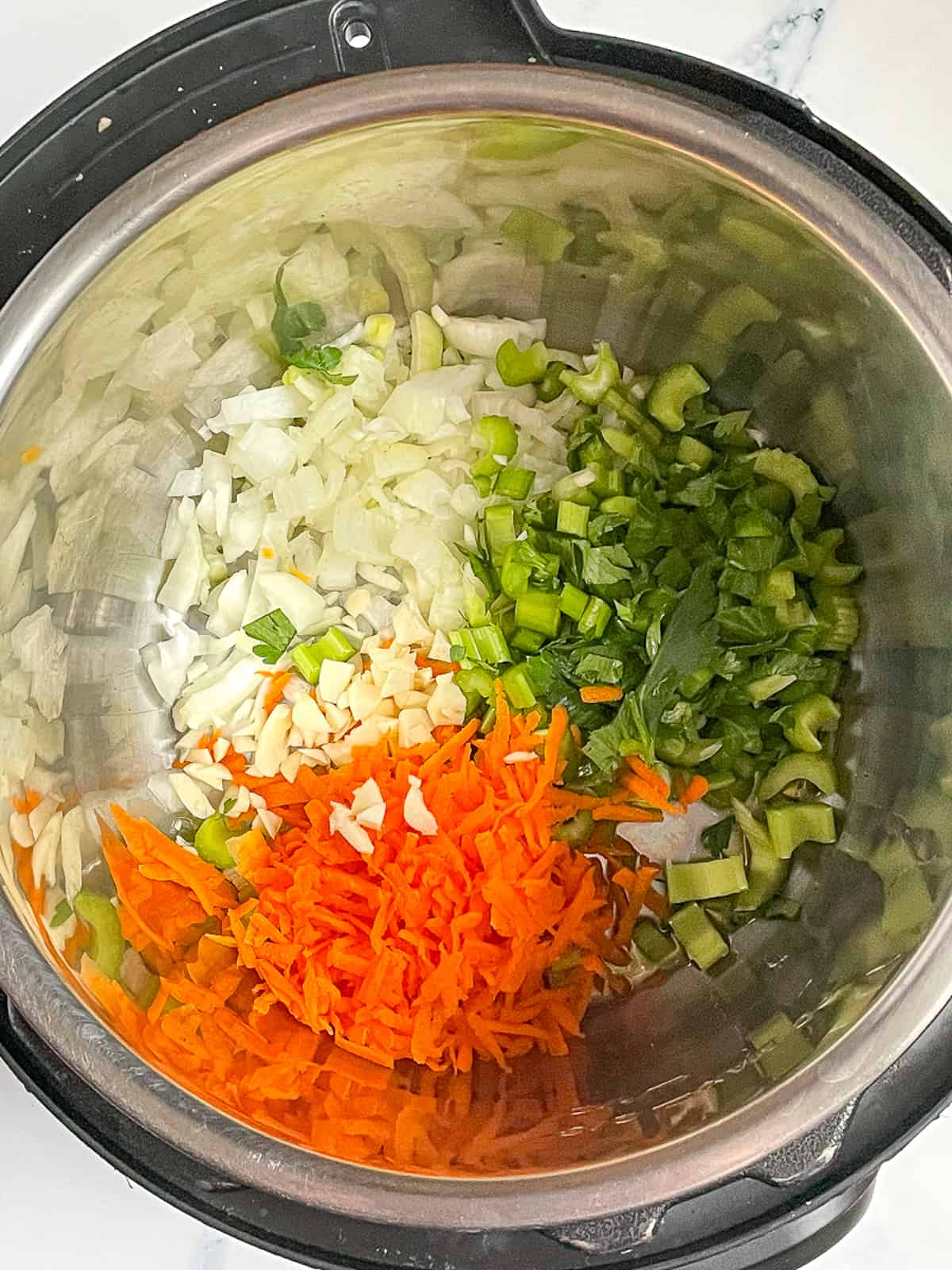 celery, onion, carrot, and garlic in the instant pot