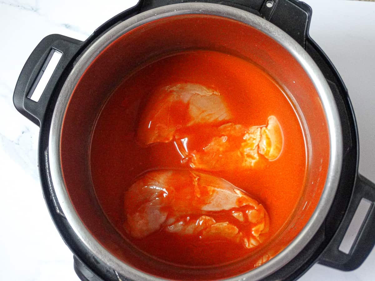 chicken breasts and buffalo sauce in the instant pot