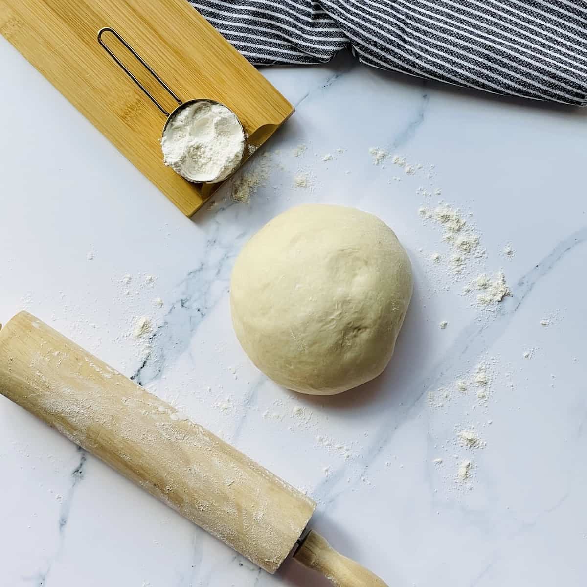 pizza dough ball rising on a white background