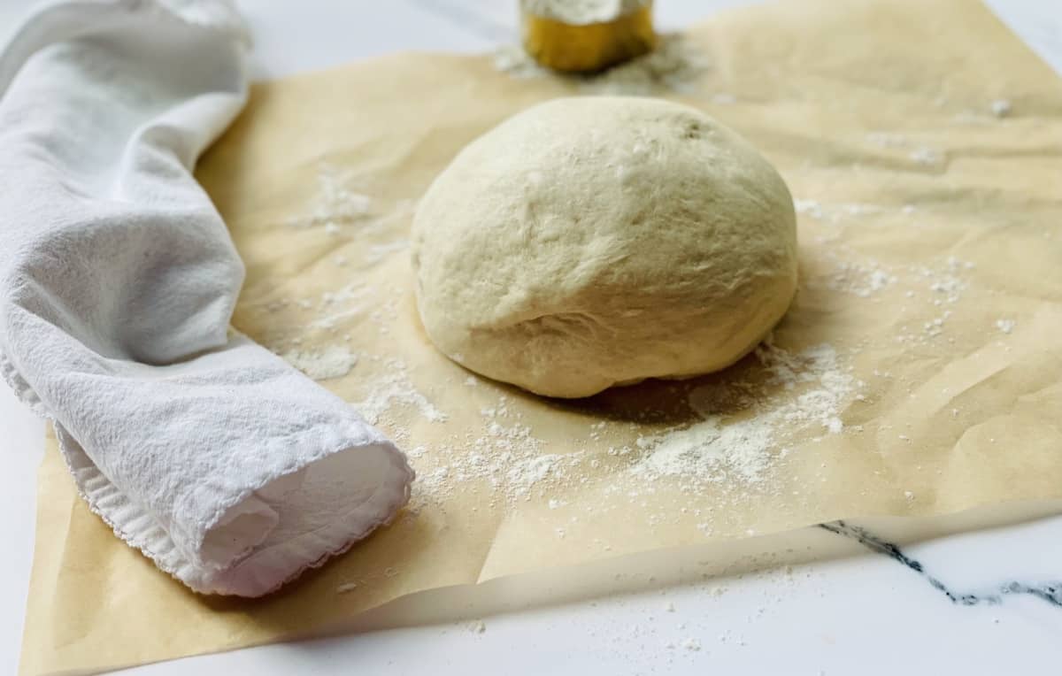 pizza dough ball on parchment paper