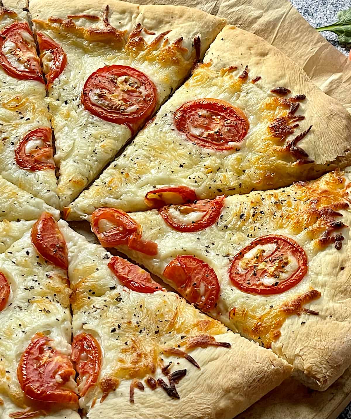 white pizza and tomatoes close up of 4 slices