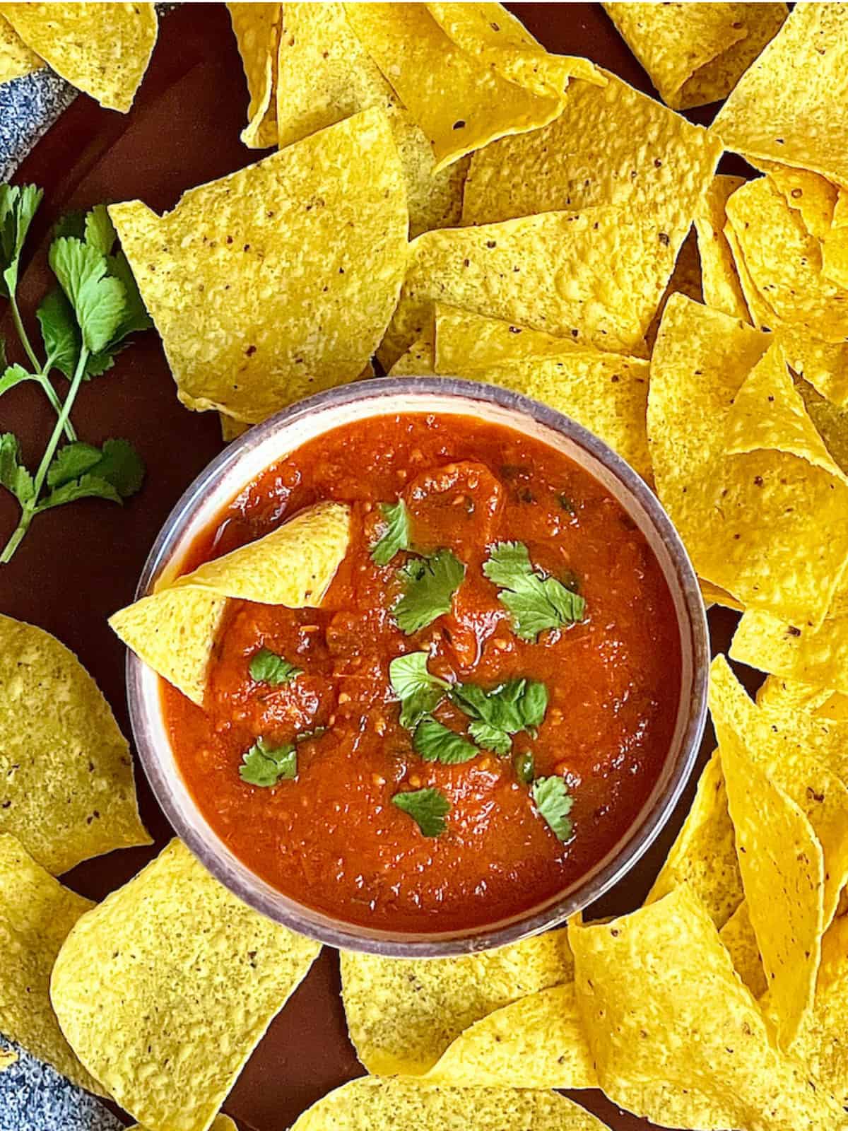 instant pot salsa in a bowl surrounded by chips