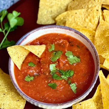 salsa roja in a bowl surrounded by chips