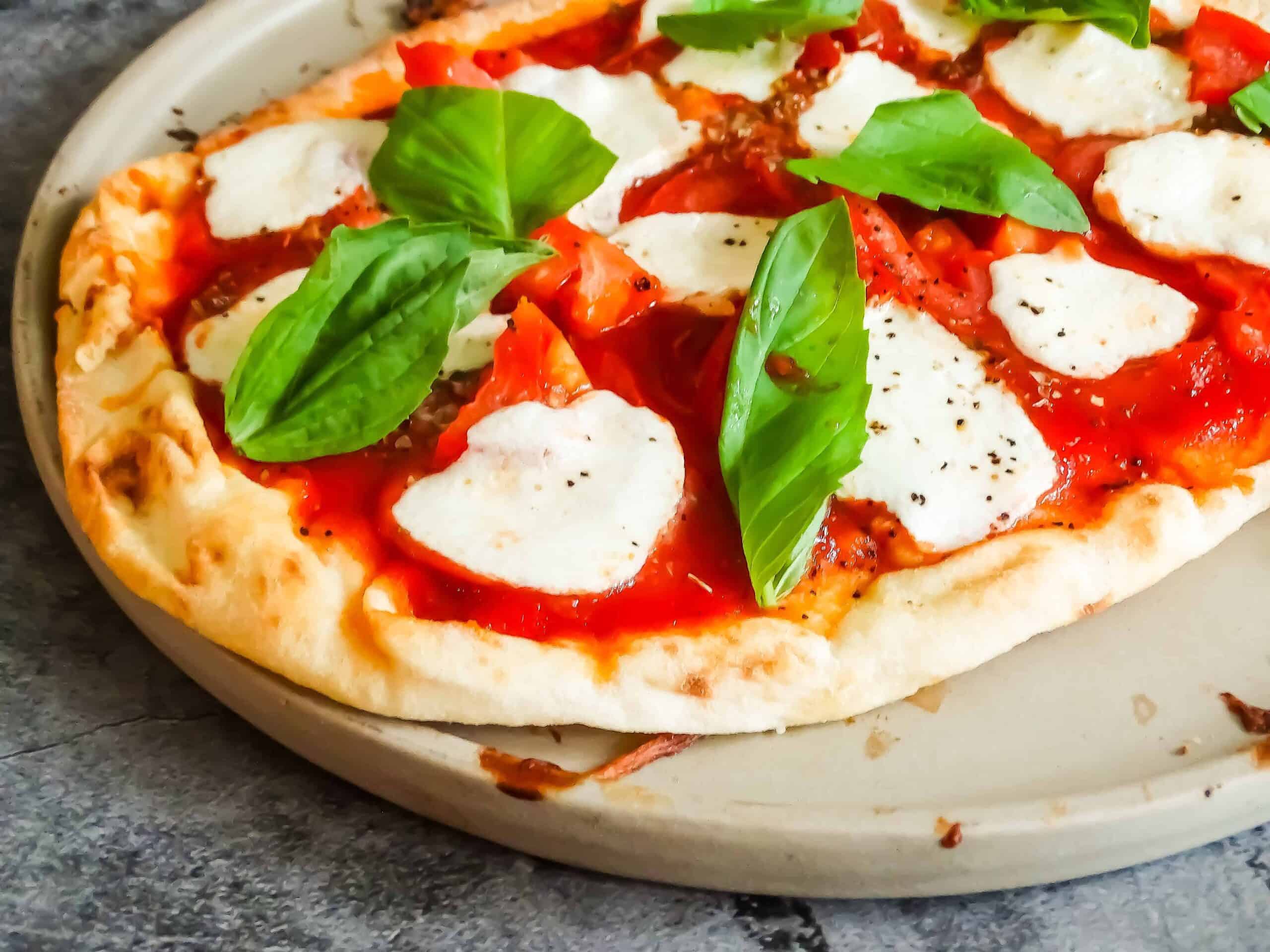 margherita pizza on a pizza stone