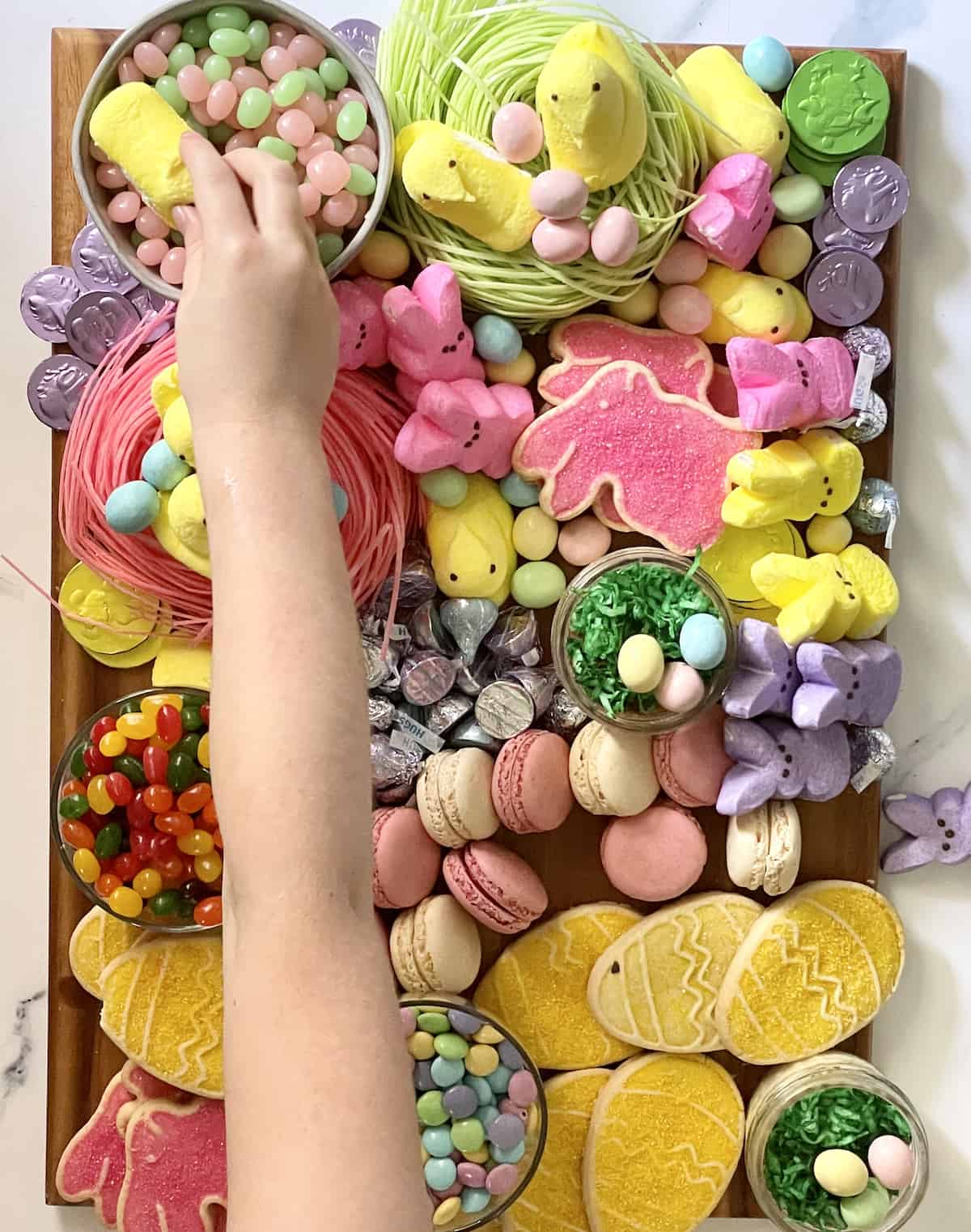 child grabbing candy off a charcuterie board