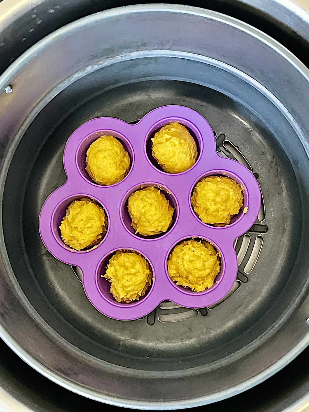 lemon cookie batter in an egg bite mold inside the air fryer