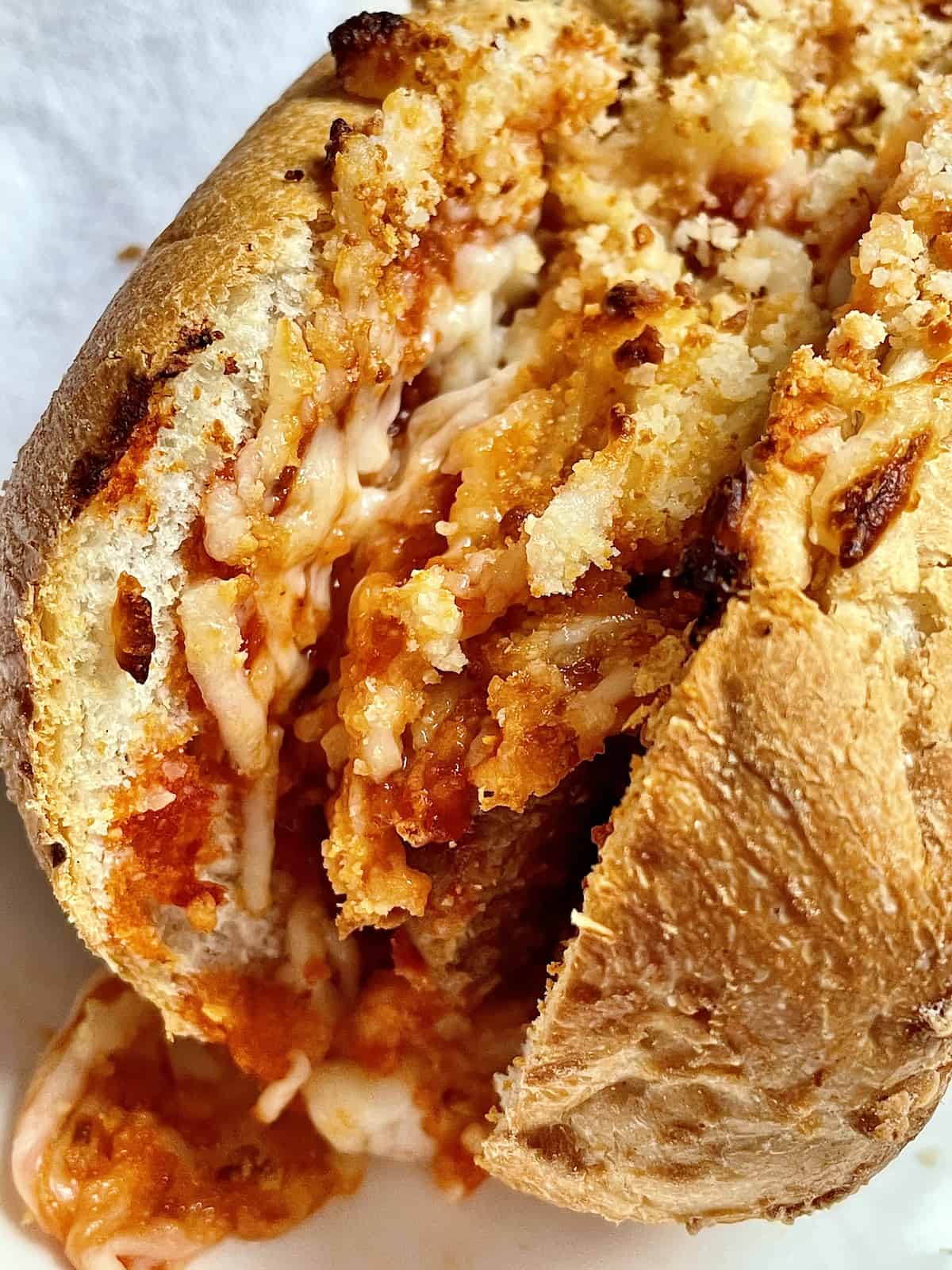 closeup of a meatball parmesan sub on a plate