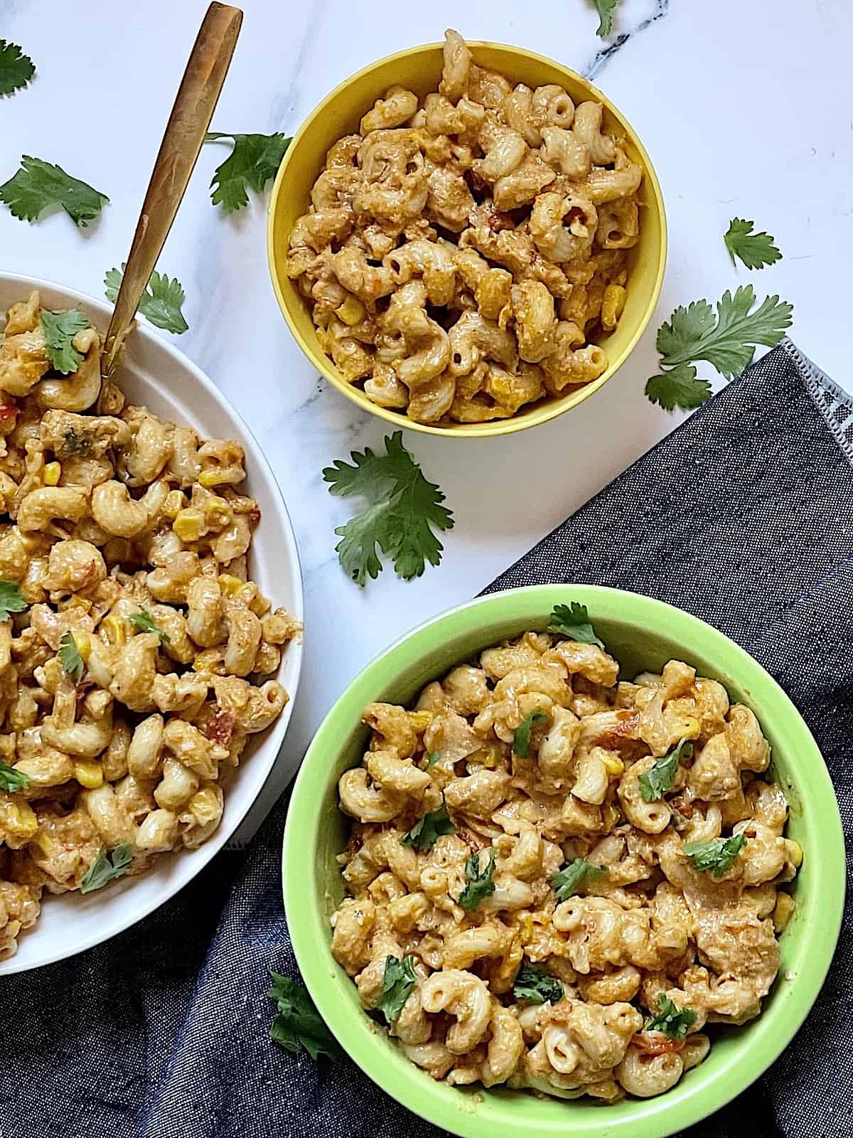 chicken taco pasta in small bowls for kids, topped with cilantro and cheese