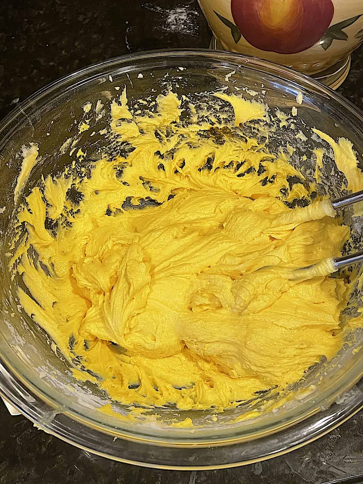 lemon cookie batter dyed yellow in a mixing bowl