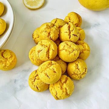 pile of lemon drop cookies coated with powdered sugar