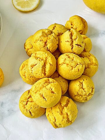 pile of lemon drop cookies coated with powdered sugar