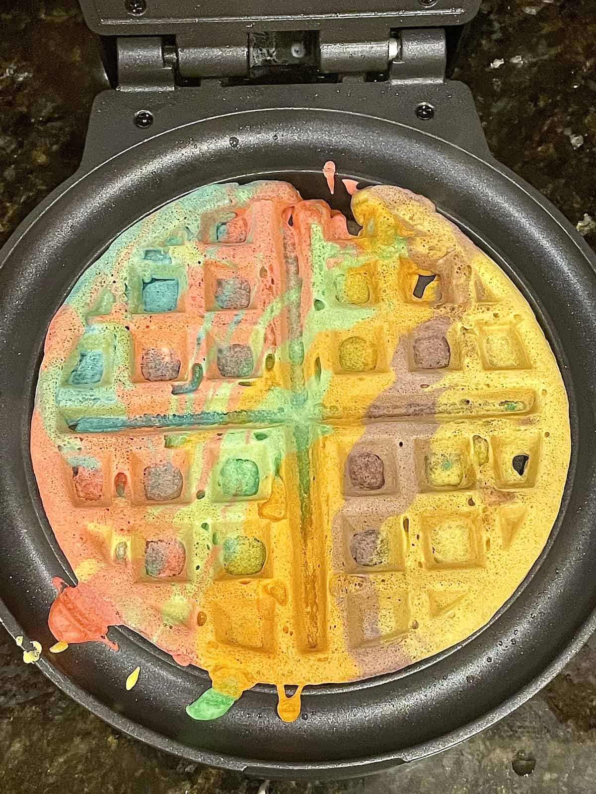 cooked rainbow waffles in a waffle maker