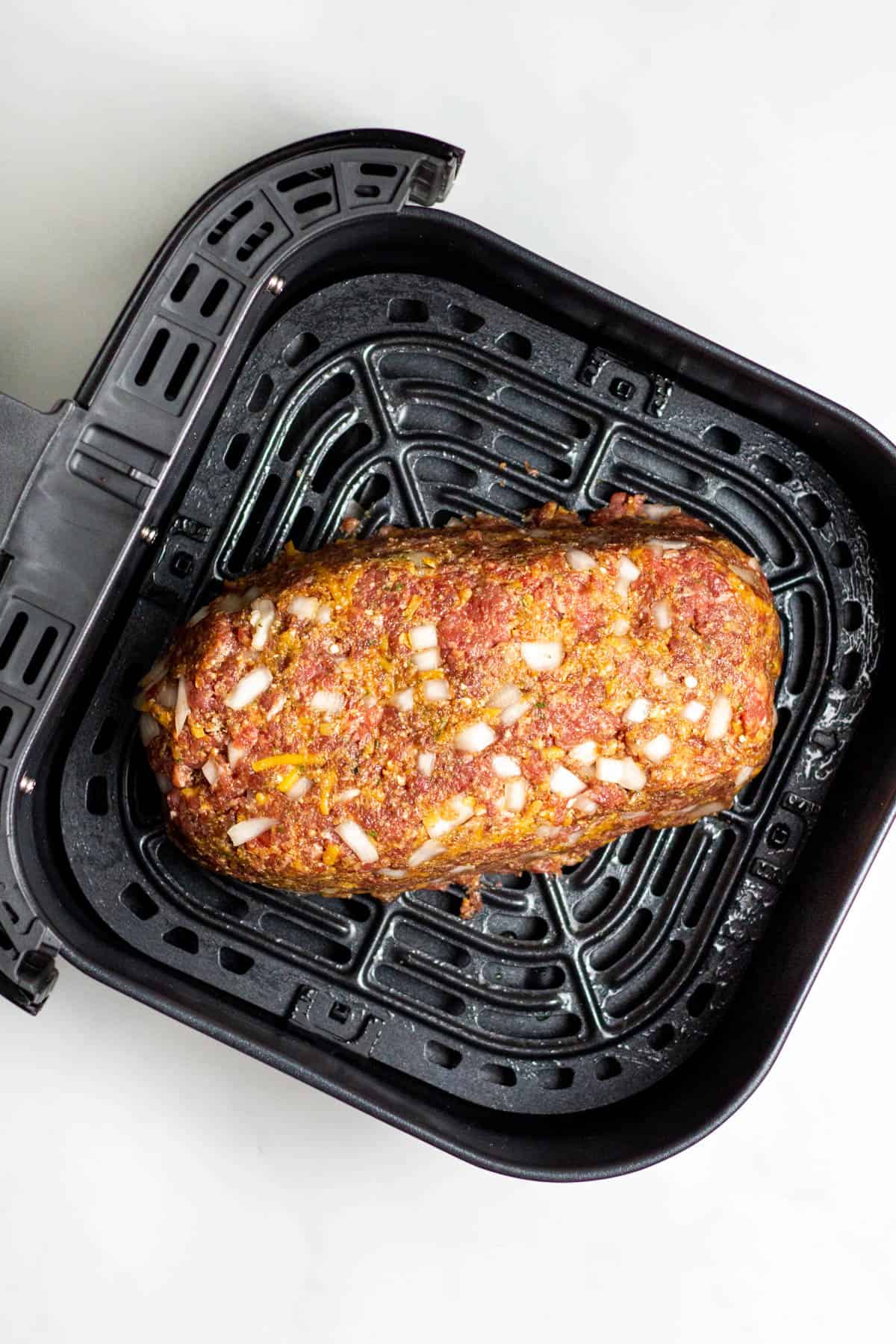 meatloaf shaped into a loaf in an air fryer