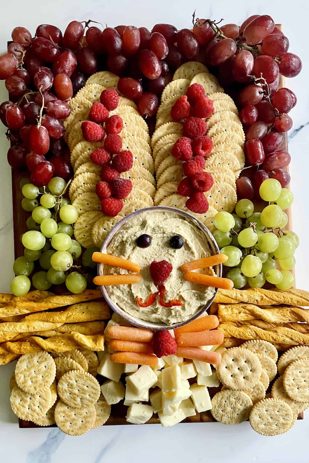 Easter Bunny platter shaped into the bunny with fruits, veggies, crackers, and cheese