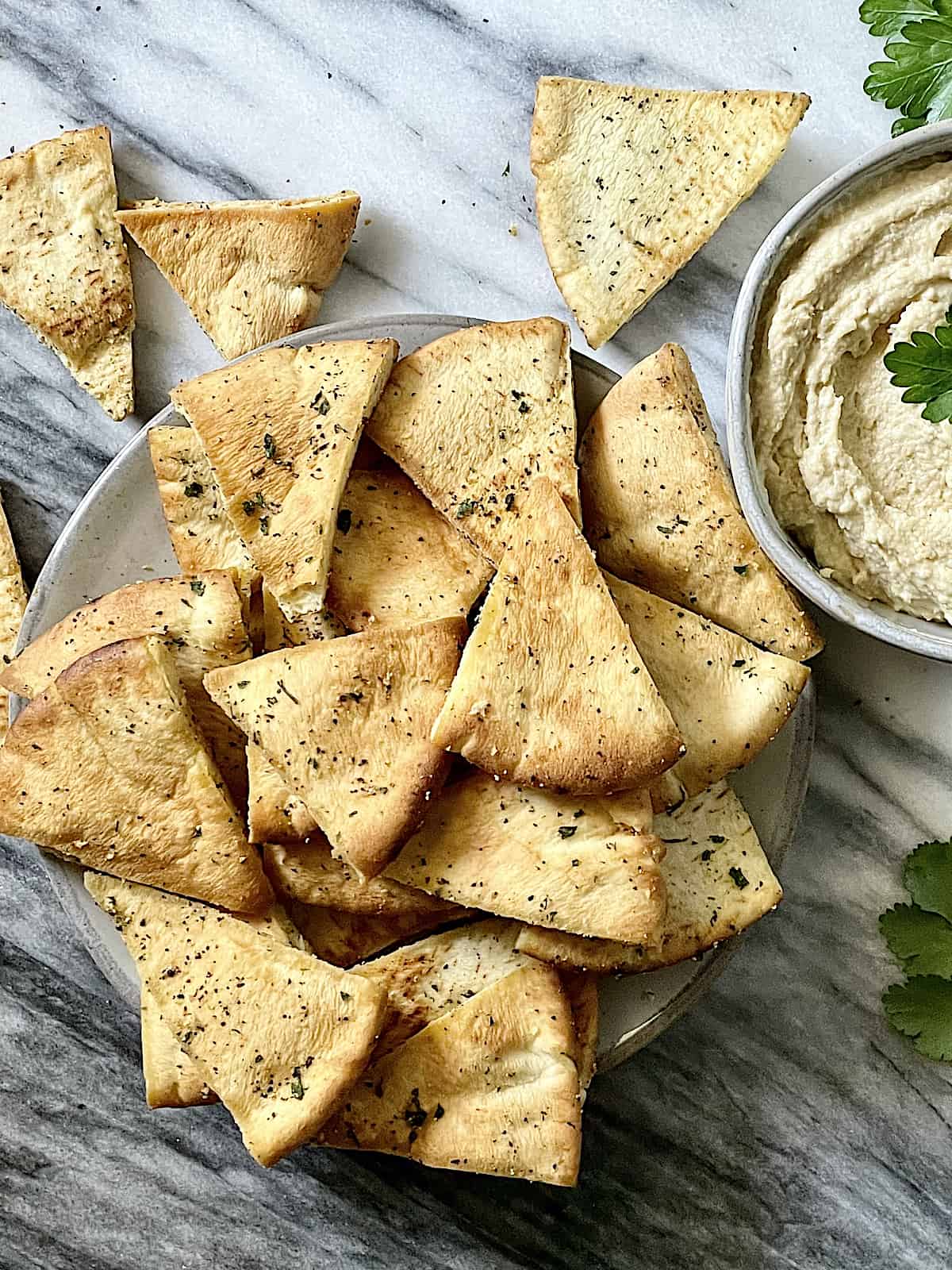 close up of air fried pita chips on a plate 