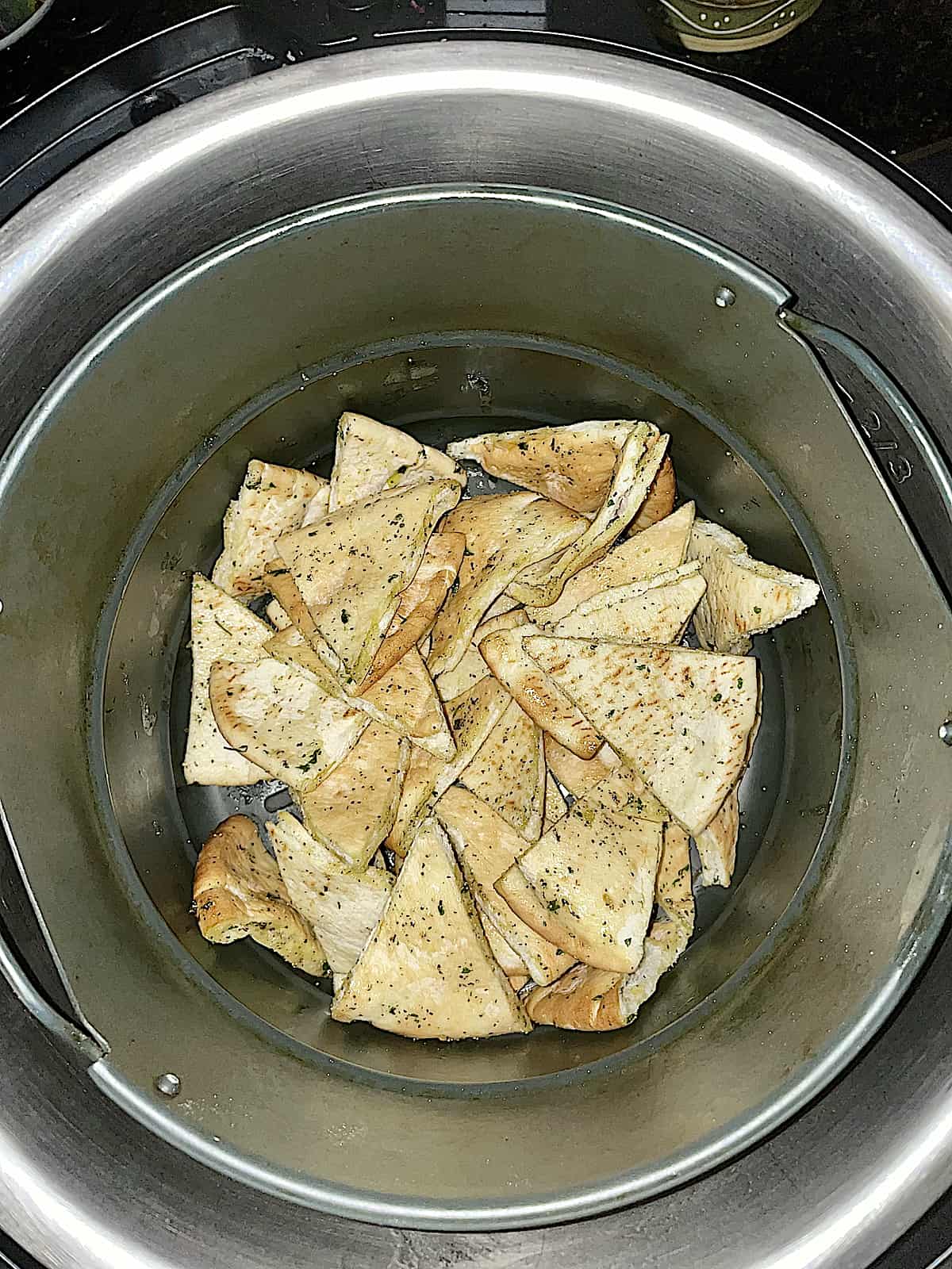 uncooked pita chips in the air fryer baskey