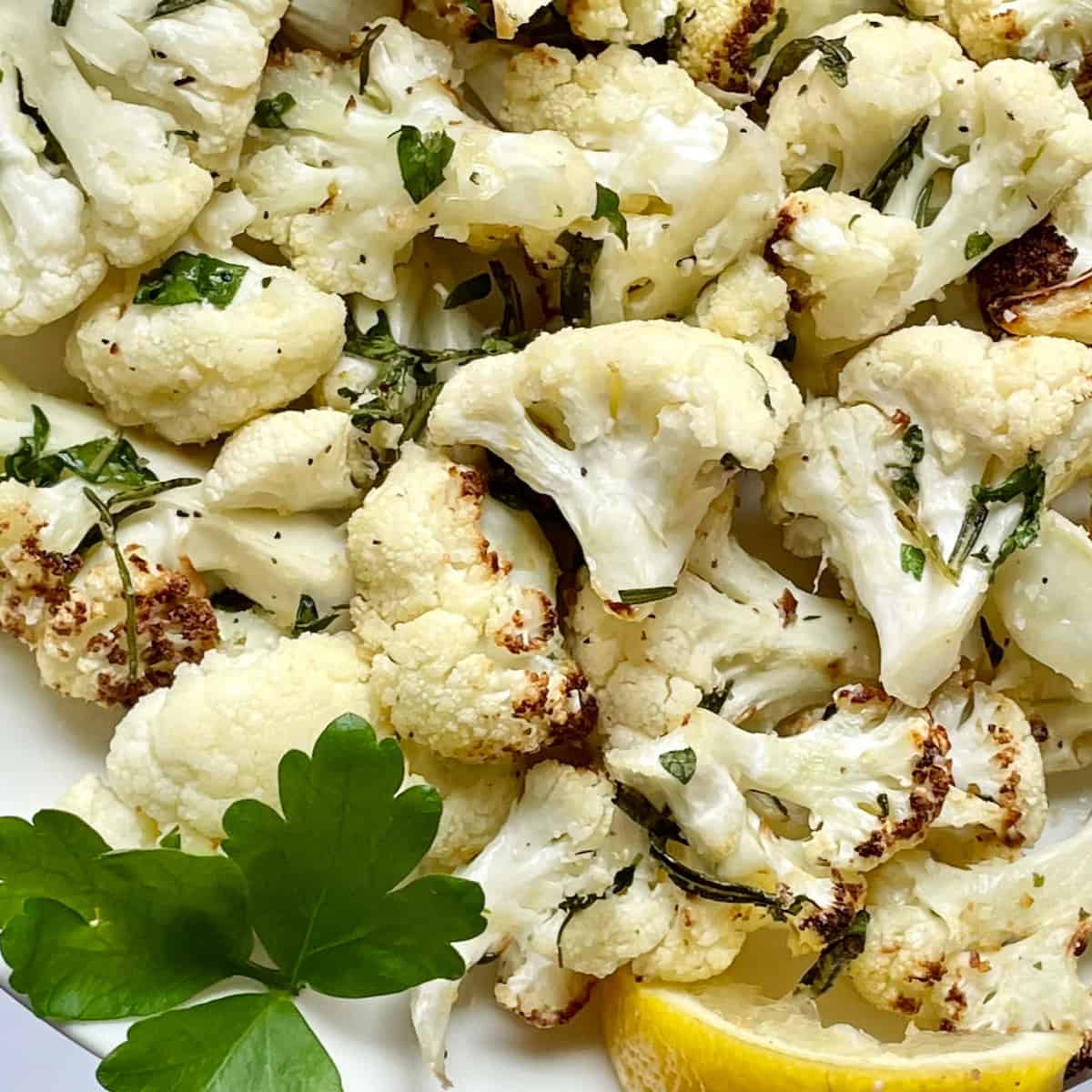 air fryer cauliflower with herbs and lemon on a plate