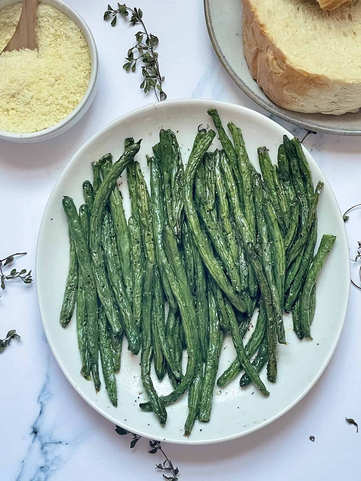 air fried green beans with salt and pepper on a white plate