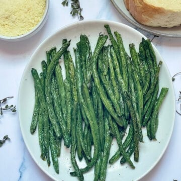 air fried green beans on a white plate