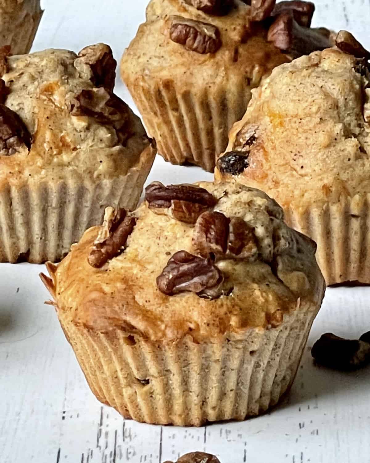 close up of a morning glory air fryer muffin with more muffins in the background